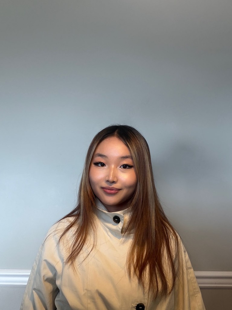 Portrait of Selina Ma in a light jacket against a plain background.