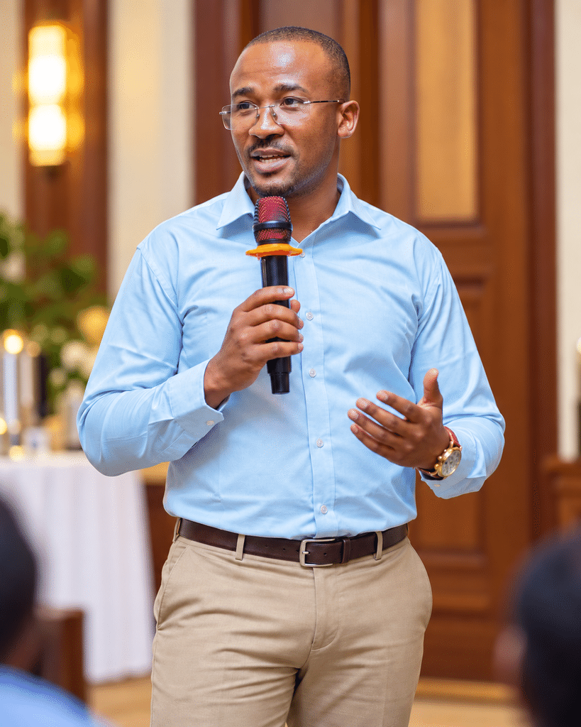 Davis Amani standing as an event speaker.